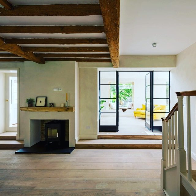 Light wood plank flooring in a living room with a step-down transition