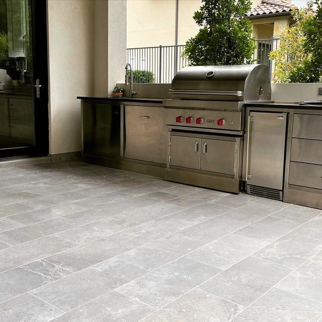 Outdoor kitchen area on large-format gray porcelain tile