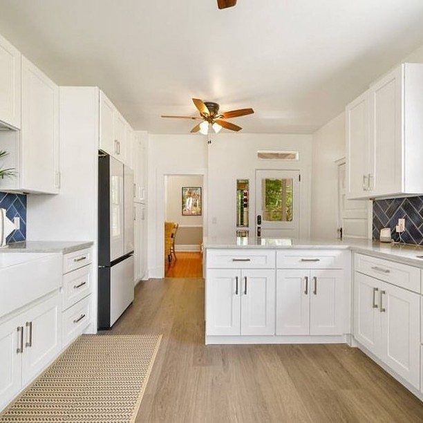 Wood-look vinyl plank flooring through a kitchen and hallway